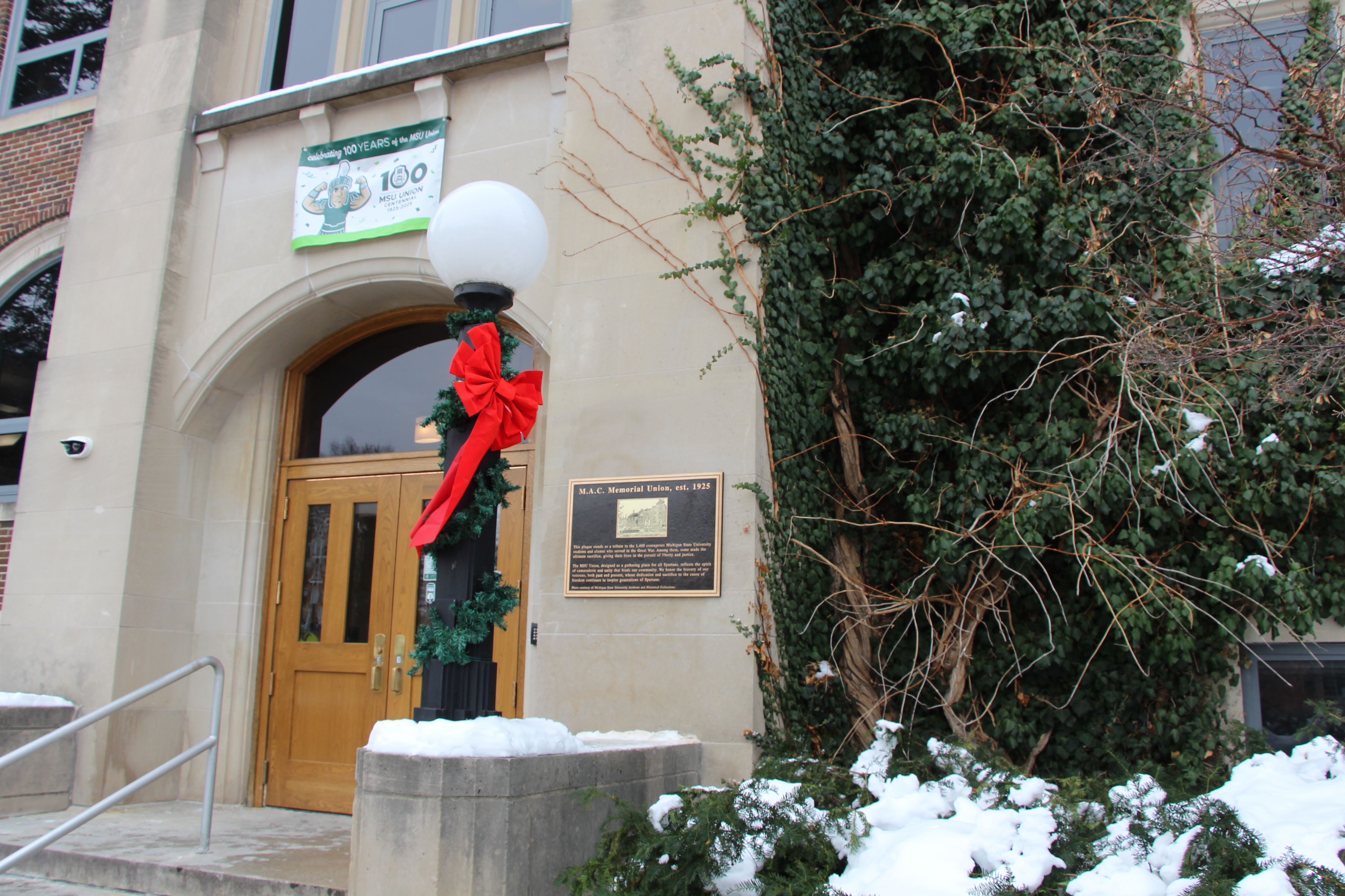 West entrance of MSU Union with ribbon around light pole and memorial plaque on building