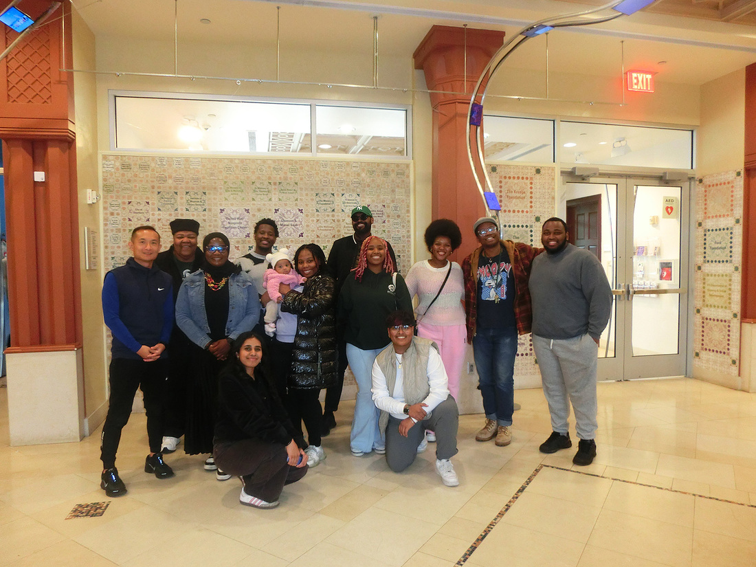 A group of student post together at the museum