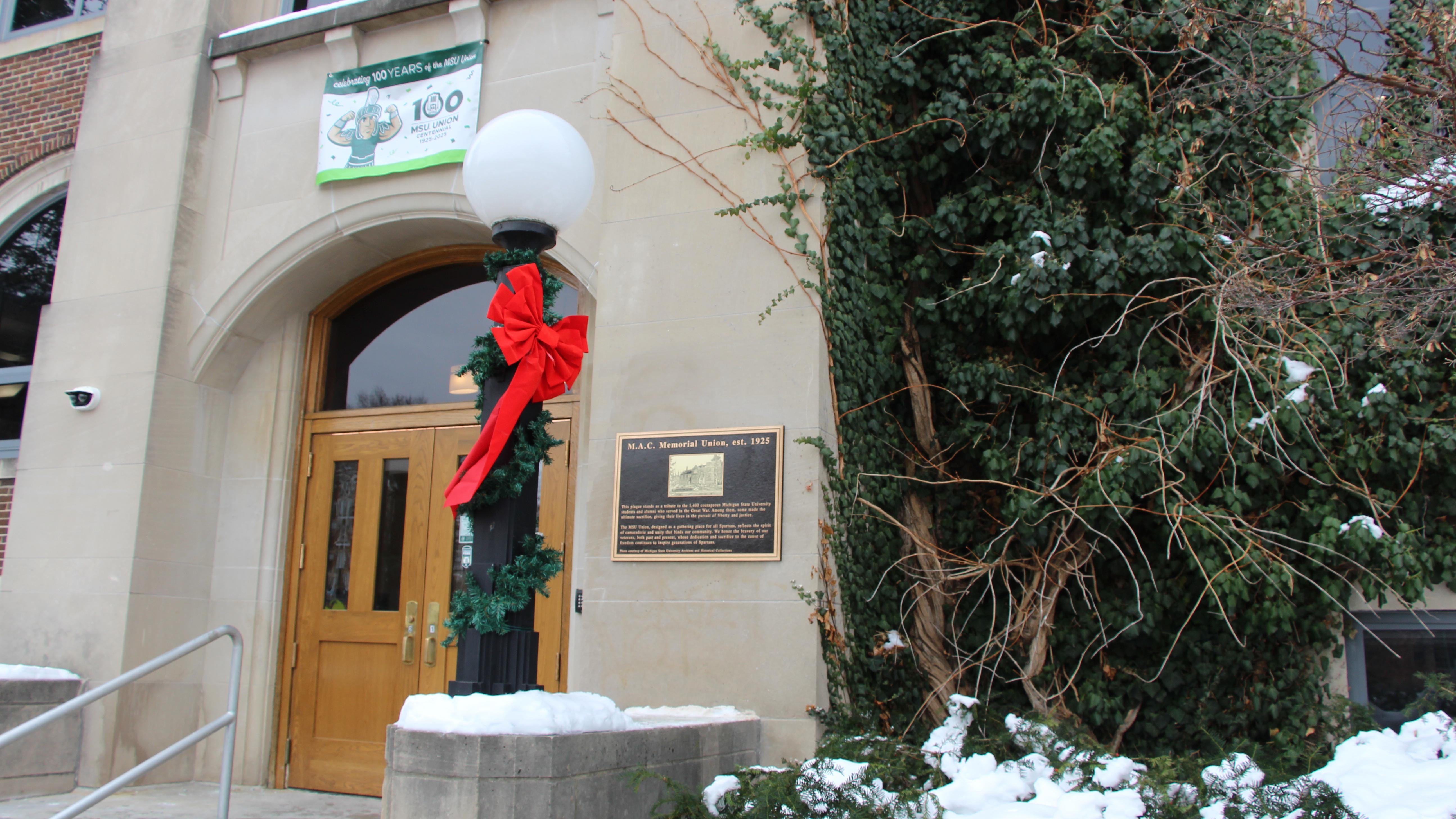 West entrance of MSU Union with ribbon around light pole and memorial plaque on building