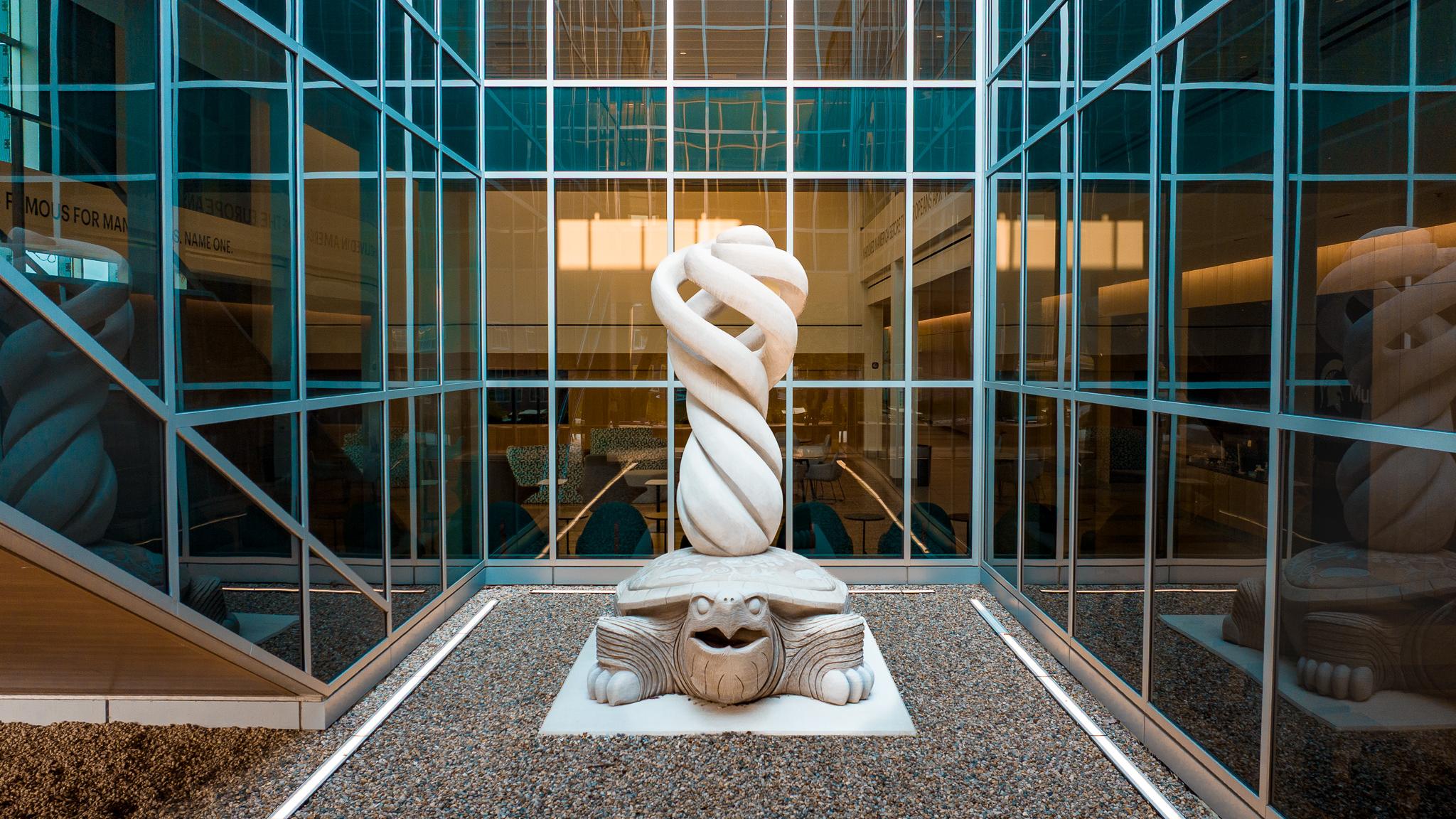 The MCC sculpture sits in a light well inside the building
